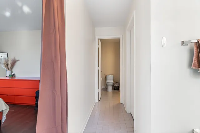 a view of a bathroom from a hallway