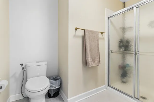 a bathroom with a toilet and a shower