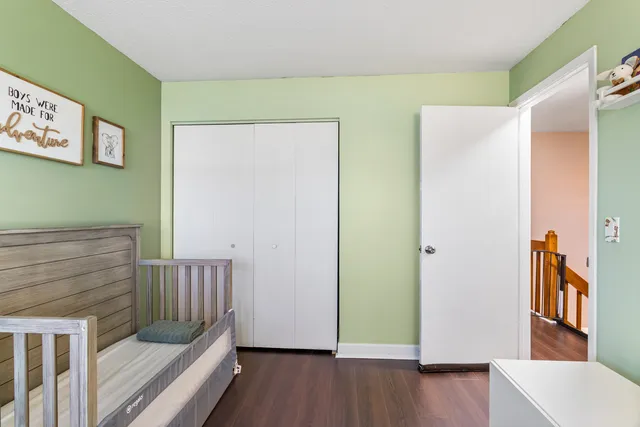 a view of a hallway with entryway and wooden floor