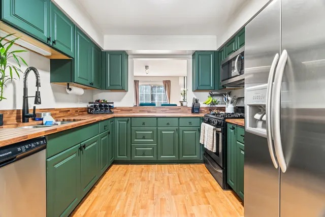 a kitchen with a sink cabinets and stainless steel appliances