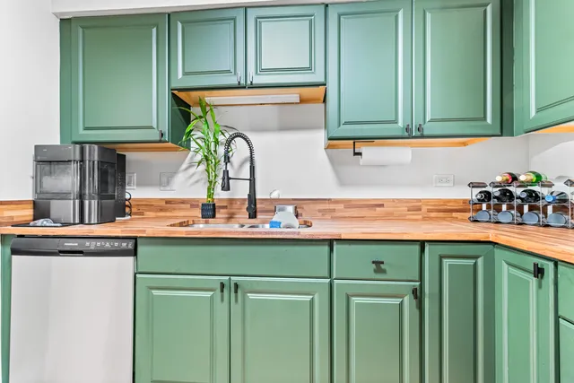 a kitchen with stainless steel appliances granite countertop a sink and a cabinets