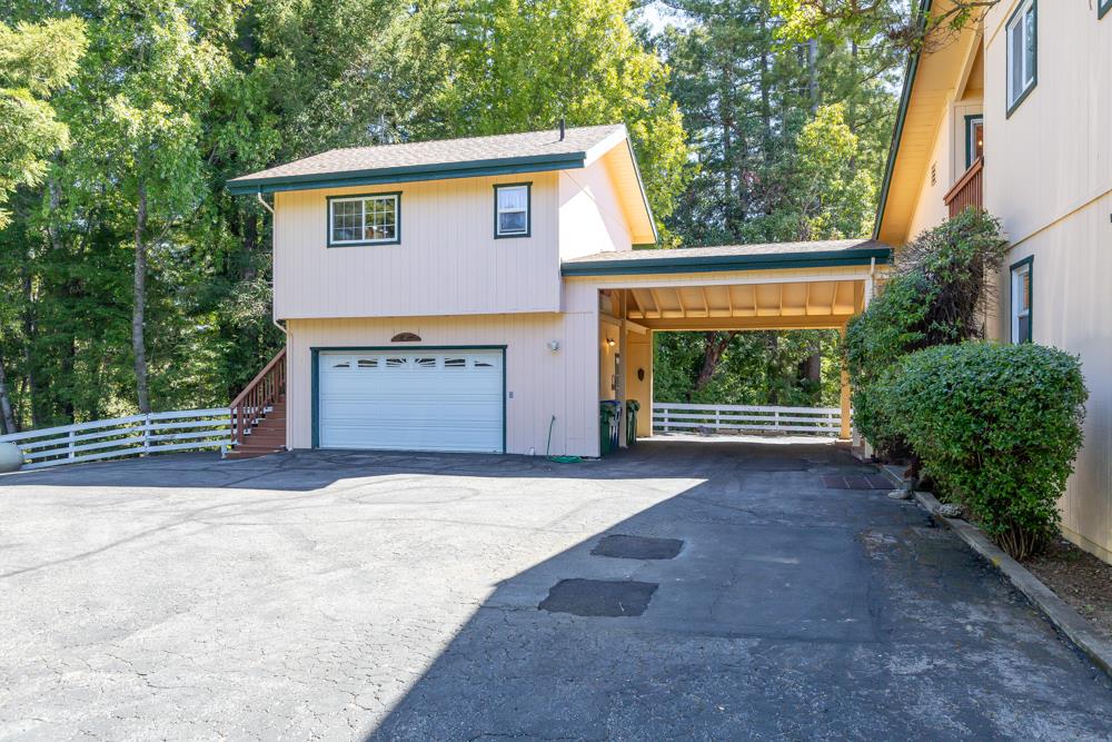708 Ralston Ridge Boulder Creek, CA 95006 - Photo 33 of 59 a front view of a house with a yard and garage