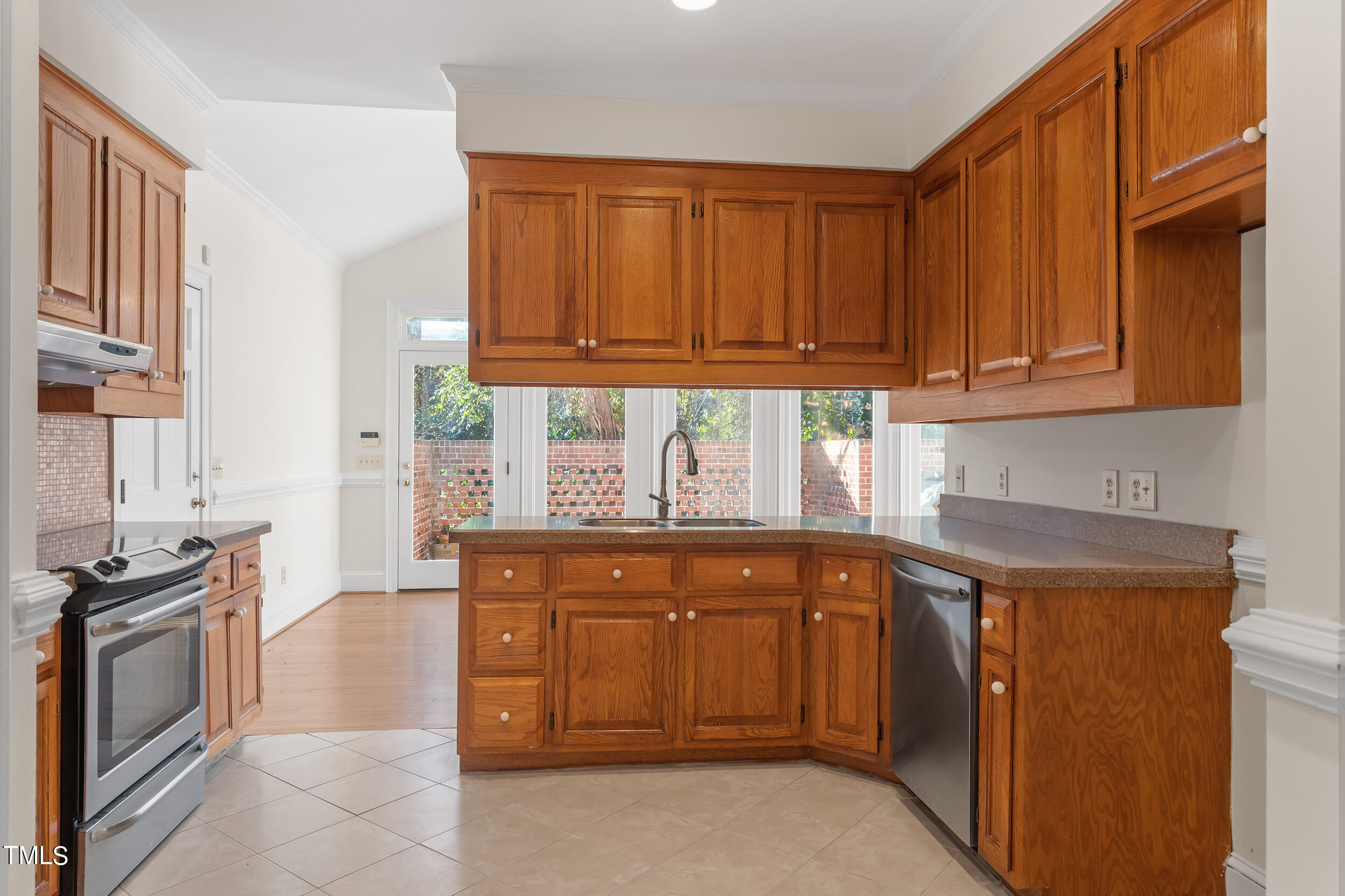 2617 Tatton Drive Raleigh, NC 27608 - Photo 19 of 41 a kitchen with stainless steel appliances granite countertop a stove a sink and a microwave