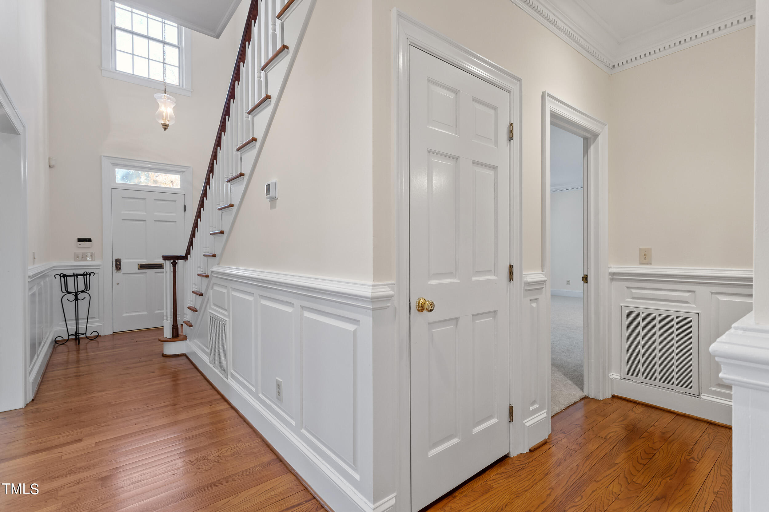 2617 Tatton Drive Raleigh, NC 27608 - Photo 21 of 41 a view of a hallway with wooden floor and staircase