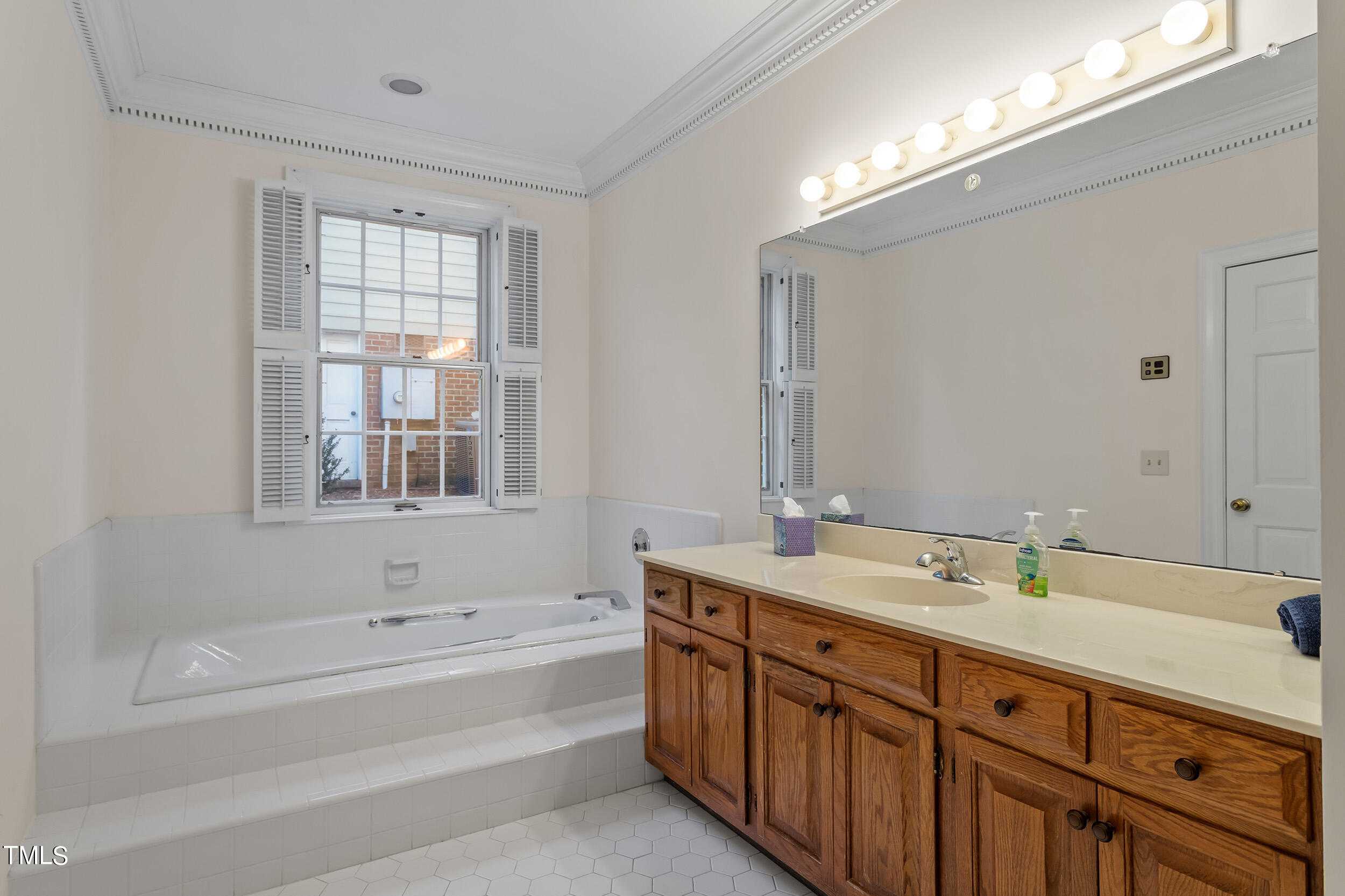 2617 Tatton Drive Raleigh, NC 27608 - Photo 26 of 41 a bathroom with a tub sink and mirror
