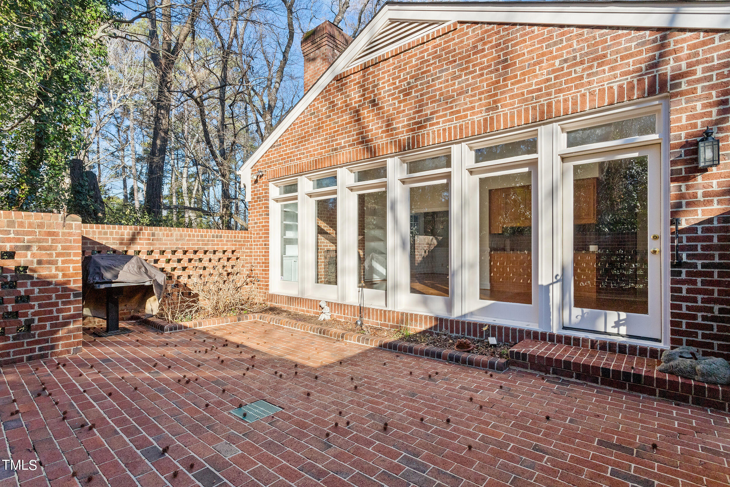 2617 Tatton Drive Raleigh, NC 27608 - Photo 6 of 41 a view of a brick house with many windows