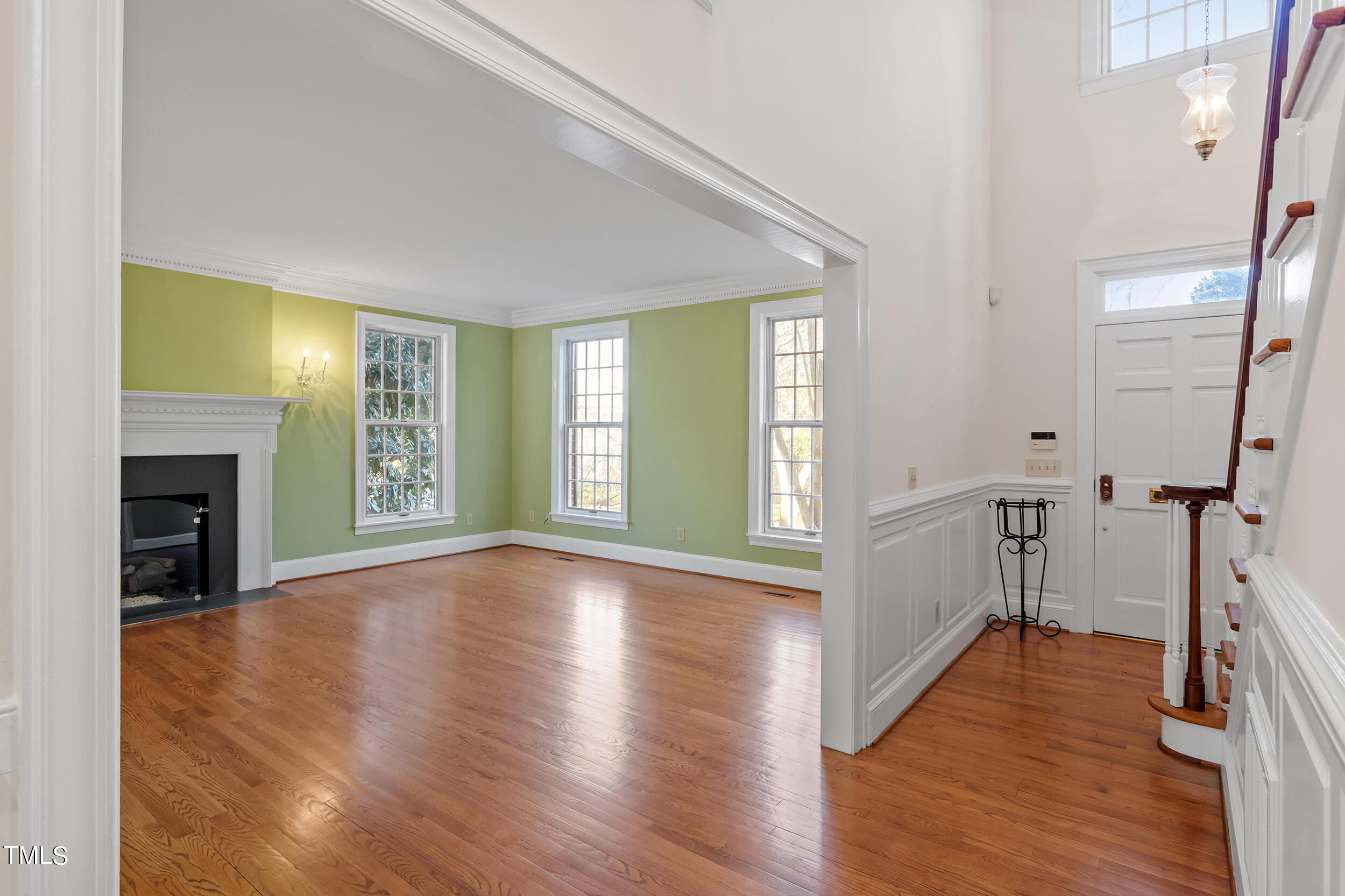 2617 Tatton Drive Raleigh, NC 27608 - Photo 8 of 41 a view of empty room with wooden floor and fireplace
