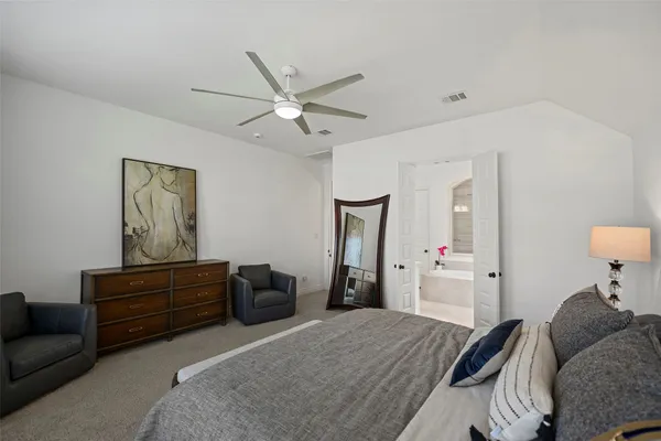 a bedroom with a bed and ceiling fan