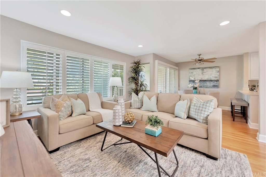 family/living room with plantation shutters, recessed lighting, designer paint, hardwood floors