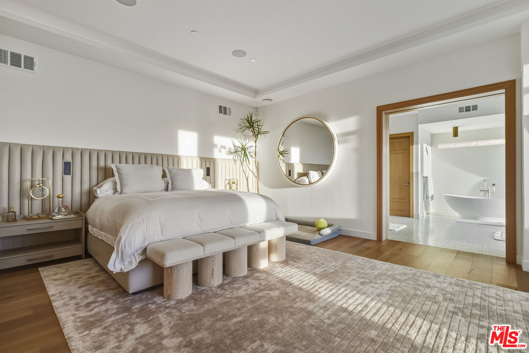 3140 Sweetwater Mesa Road Malibu, CA 90265 - Photo 37 of 71 a bed room with a bed mirror and a table