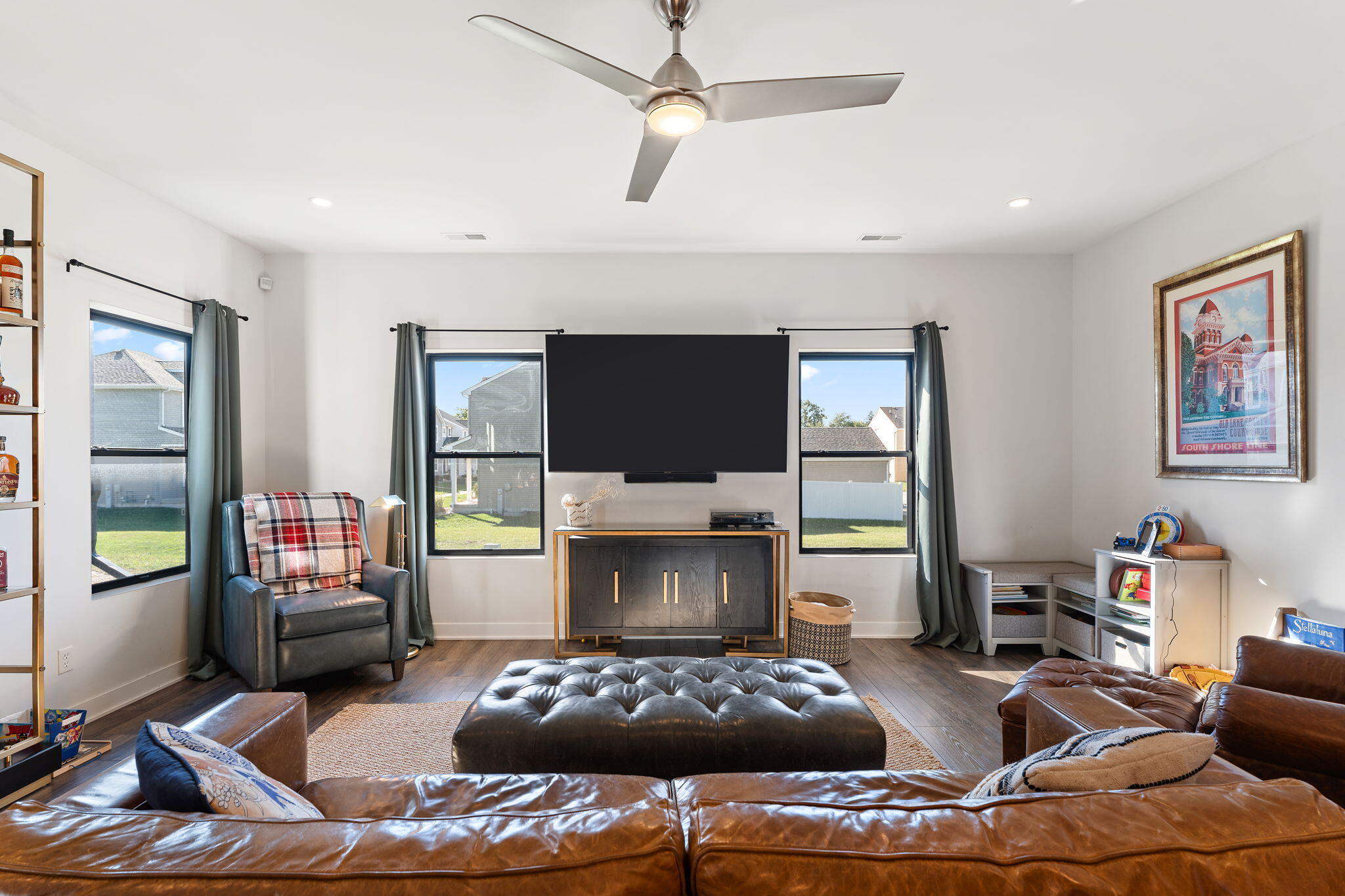 283 Nomo Place Crown Point, IN 46307 - Photo 14 of 35 a living room with furniture a flat screen tv and a floor to ceiling window