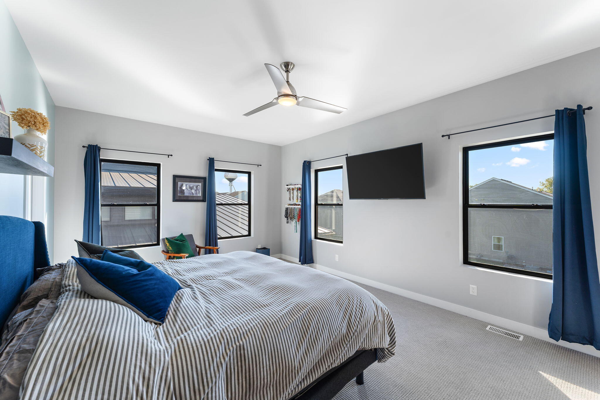 283 Nomo Place Crown Point, IN 46307 - Photo 22 of 35 a bedroom with a bed window and a flat screen tv