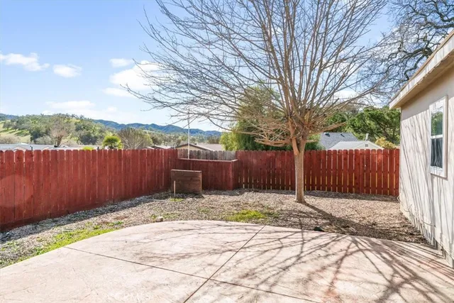 a view of a house with a wooden fence