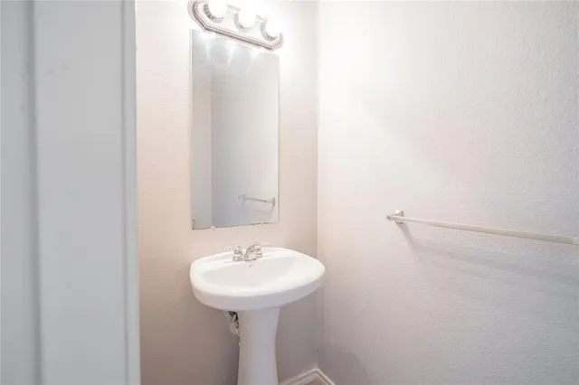 a bathroom with a sink and mirror