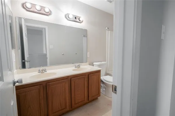 a view of bathroom with a sink and a mirror