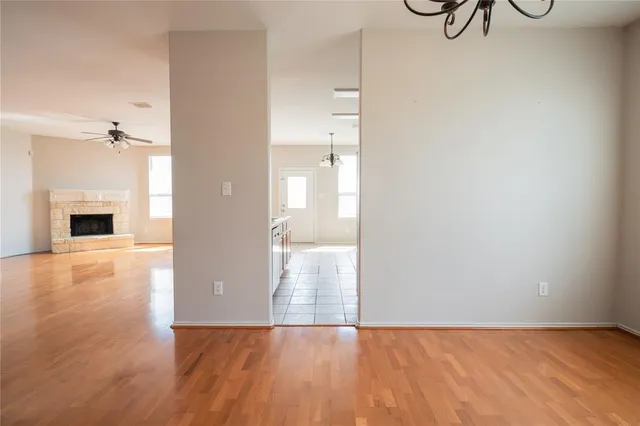 a view of a room with wooden floor and fireplace