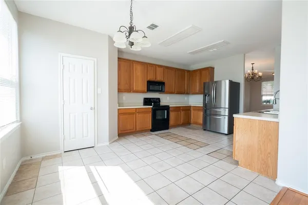 a large kitchen with cabinets and stainless steel appliances
