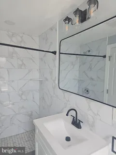 a bathroom with a sink and shower