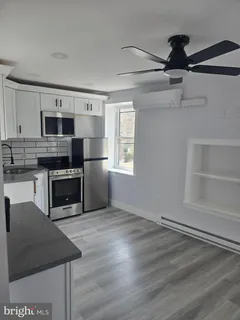 a kitchen with stainless steel appliances granite countertop a stove a microwave and a refrigerator
