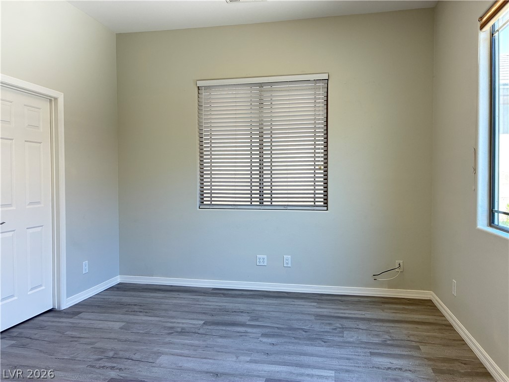 10 Caprington Road Henderson, NV 89052 - Photo 34 of 44 Newly installed laminate flooring enhances this naturally illuminated space with modern window treatments.