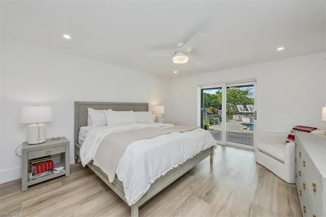 a bedroom with a bed and a wooden floor