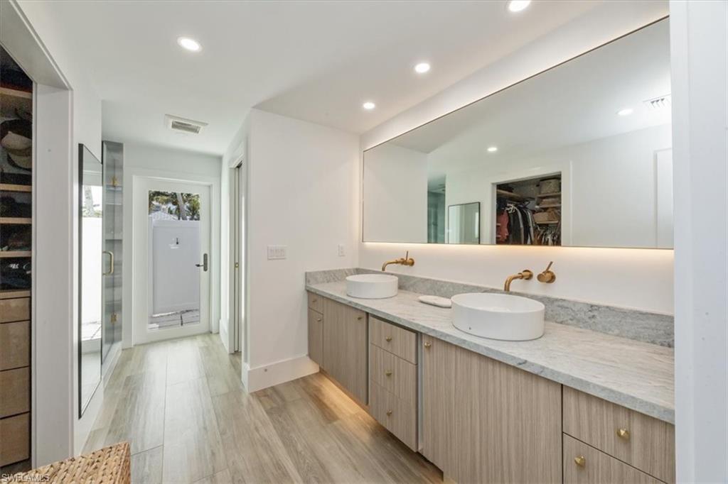1570 Bonita Lane Naples, FL 34102 - Photo 12 of 22 a bathroom with a granite countertop double vanity sink and mirror