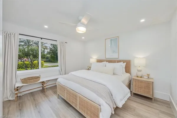 a bedroom with a large bed and a large window