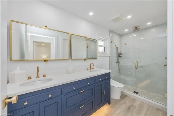 a bathroom with a granite countertop sink mirror and bathtub