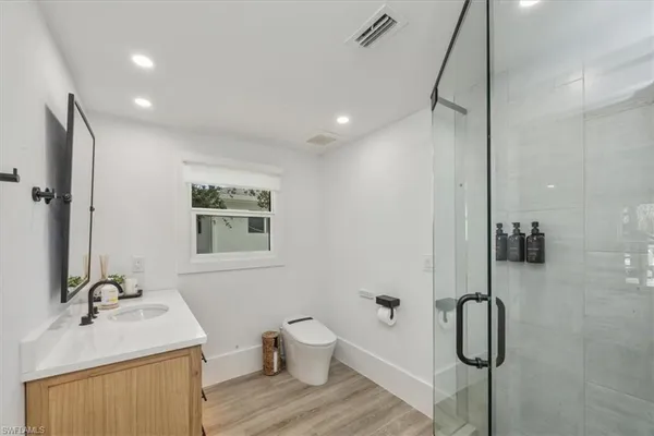 a bathroom with a sink toilet and shower