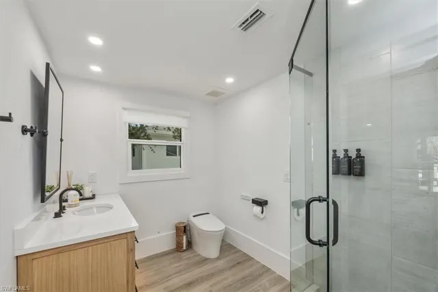 a bathroom with a sink toilet and shower