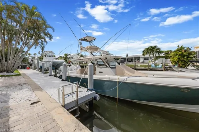 a view of a swimming pool with a patio and a yard