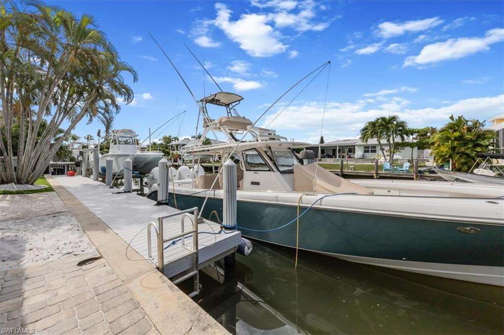 1570 Bonita Lane Naples, FL 34102 - Photo 20 of 22 a view of a swimming pool with a patio and a yard