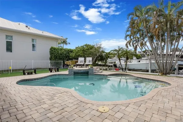 a view of a swimming pool with a yard