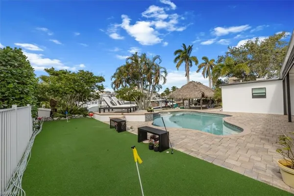 a view of a house with swimming pool and a yard