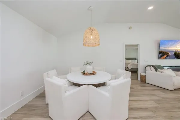 a view of a dining room with furniture and wooden floor