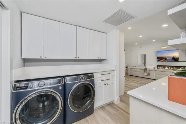 a view of a kitchen with stainless steel appliances granite countertop cabinets and a stove top oven