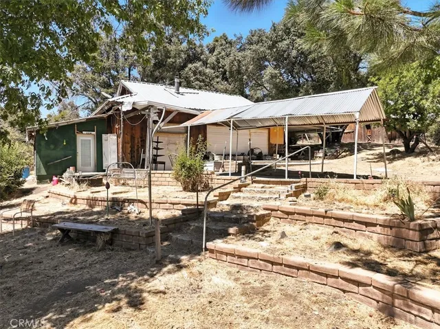 a view of a patio with chairs and a table and chairs with wooden fence