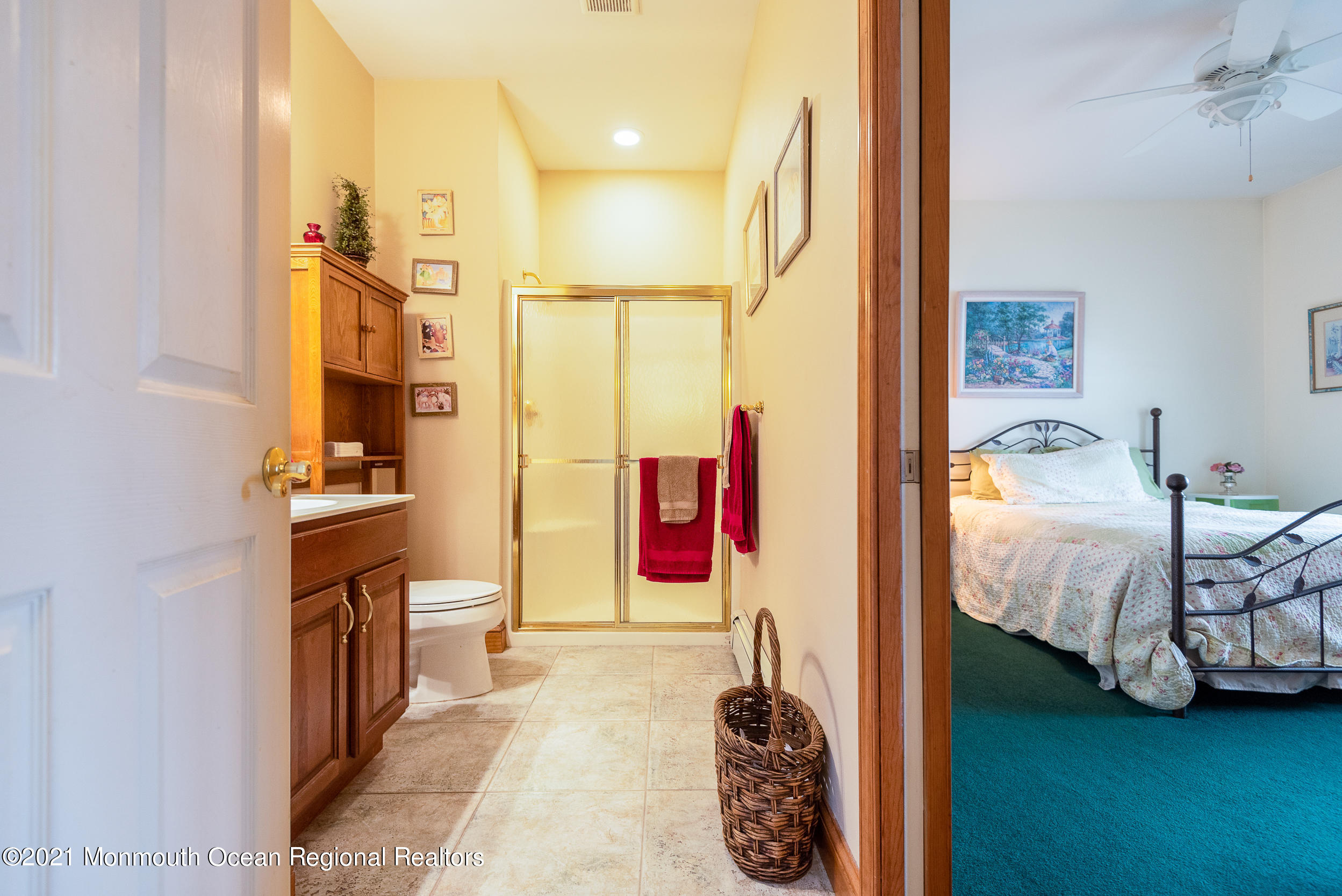 2100 Red Gate Road Allenwood, NJ 08720 - Photo 21 of 61 a bedroom with a bed and a chandelier