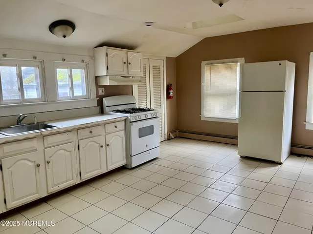 a kitchen with stainless steel appliances a refrigerator sink and cabinets