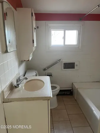 a bathroom with a sink toilet and mirror