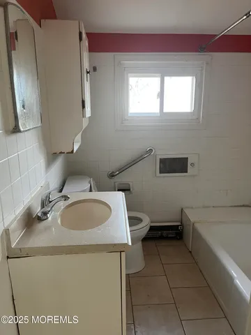 a bathroom with a sink toilet and mirror