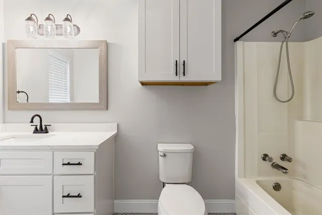 a bathroom with a sink a toilet and a bathtub