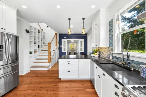 a kitchen with stainless steel appliances a sink stove and refrigerator