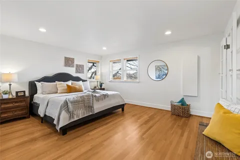 a spacious bedroom with a bed and a cabinets