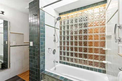 a bathroom with a bathtub and a shower