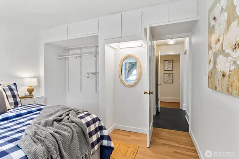 a bedroom with a bed and a mirror