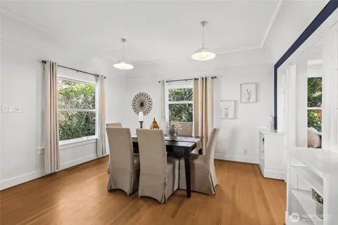 a view of a dining room with furniture window and wooden floor
