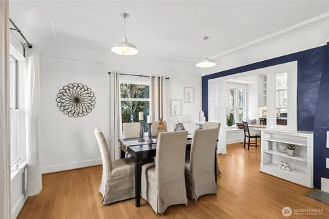 a view of a dining room with furniture window and wooden floor