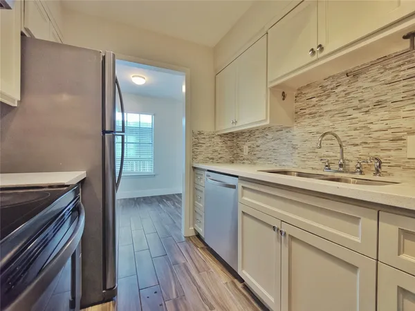 a view of a kitchen from the hallway