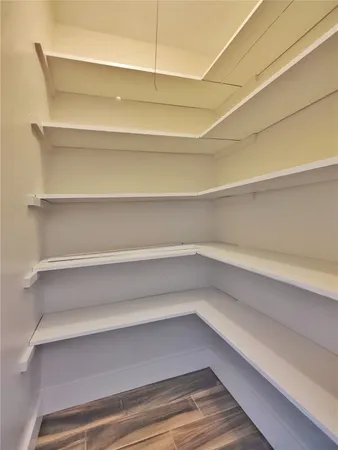 a view of walk in closet with empty racks